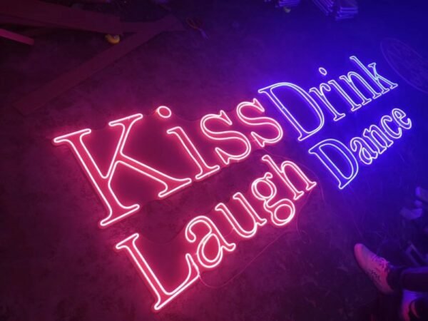 kiss drink laugh dance neon sign